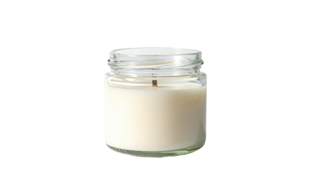 Small glass jar candle with white wax against a black background
