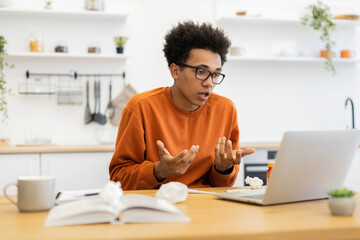 A young man with glasses is on a video call, possibly consulting with a doctor or attending a virtual meeting.