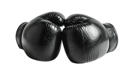 Two black boxing gloves facing each other against black backdrop