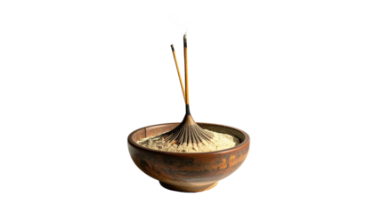 Incense sticks in a ceramic bowl filled with coarse material