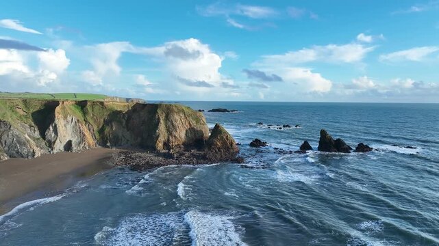 Irish drone seascapes cliffs and sea stacks Benvoy Beach Copper Coast Waterford bright autumn morning