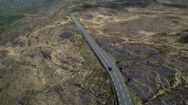 Drone Shot of Black Car Moving on Road in Caga Mountains, Cork County, Republic or Ireland