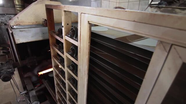 Interior shot of local bakery moving belt with bread heading toward the oven