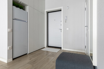Modern Entryway Interior with White Door and Built-in Storage