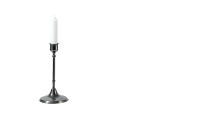 Single white candle stands on dark metal holder on black