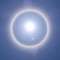 The sun shines brightly in the sky and natural phenomenon called circumscribed halo