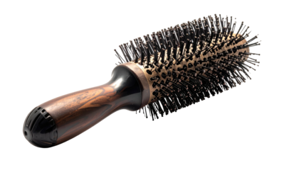 Round hairbrush with wood handle, boar bristles on dark backdrop