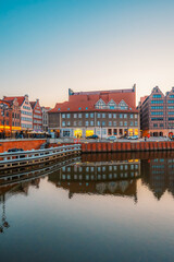 Gdansk with Motlawa river in Poland. Old town colourful house with saint Marys church i main square.