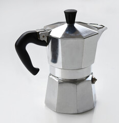 Classic silver moka pot isolated on a white background. Vintage Italian coffee maker with black handle, ideal for brewing espresso at home. Perfect for kitchen, cafe or coffee-themed design.