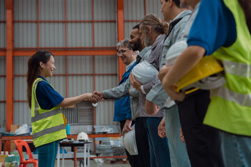A group of engineers and staff members are discussing their work while working in a metal sheet and...