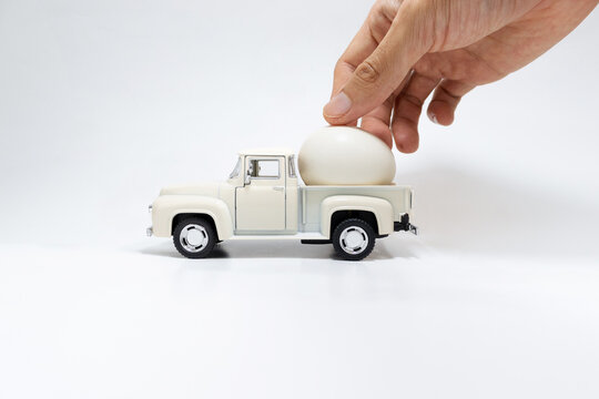 Toy car with egg in it isolated on a white background. After edits.