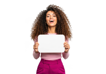 Joyful young woman with voluminous curly hair holding a white blank sign with a wide smile isolated on transparent background