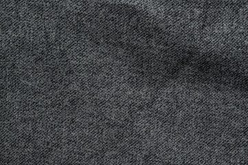 Close-up of dark gray fabric texture with subtle diagonal weave