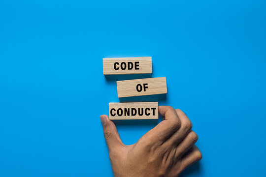 code of conduct words on wooden blocks isolated on blue background