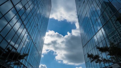 Modern Architectural Structures Reflecting Blue Sky and Clouds in Daylight