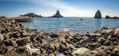 Islands of the Cyclops, off the coast of Aci Trezza, Sicily. These tall, prominent sea stacks, were, according to local legend, the great stones thrown at Odysseus in the epic poem The Odyssey.