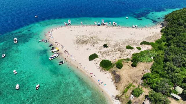 Aerial drone cinematic video of scenic caves and turquoise beach in paradise island of Marathonisi in bay of Laganas, visited by small boats a true tourist attraction, Zakithnos island, Ionian, Greece