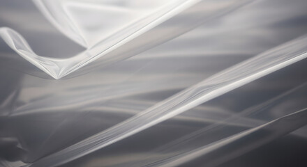 Abstract white fabric background with soft folds and shadows creating a sense of depth and texture, ideal for elegant and minimalist designs