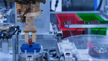 Close up industrial automation robotic working with red metalwork on smart manufacturing and right copy space on blue tone background, industry 4.0 and modern technology