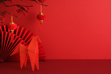 Lunar New Year, year of the horse concept. Origami horse, hanging lanterns, plum blossoms, and a...