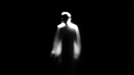 Mysterious figure in shadows creates a haunting atmosphere in a dark space at night