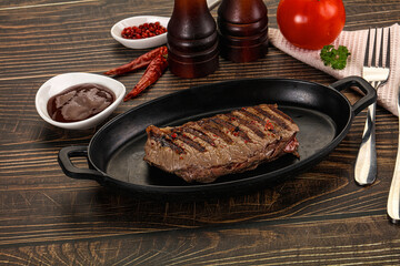 Grilled beef striploin steak with sauce