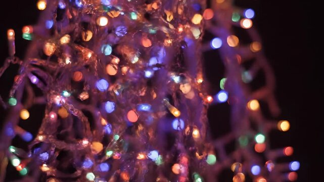 Dynamic abstract motion graphics featuring strands of glowing Christmas lights forming a complex, looping pattern of festive illumination electronic, motion design, light streaks
