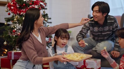 Asian happy family enjoying Christmas celebration together at home. 