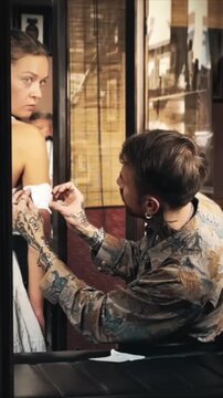 Tattoo Artist Applying Stencil to Client&rsquo;s Arm Before Tattooing