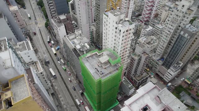 Hong Kong top-down Aerial view over the Kowloon district, and busy Mong Kok streets with some buildings in construction