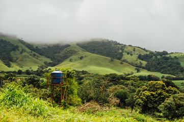 Blue water tank and misty green hills near Monteverde, Costa Rica