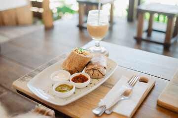 Vegan burrito with smoothie on wooden table, Puerto Viejo, Costa Rica