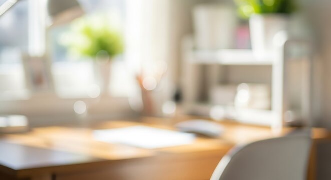 Blurred background of a bright home office with a wooden desk and window light. - Powered by Adobe