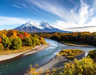 A vibrant autumnal scene with snow-capped mountains and a winding river amidst colorful trees under a blue sky