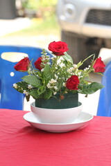 Red roses bouquet in vase, closeup of photo.