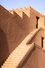 Ancient nizwa fort mudbrick stairs and wall in oman