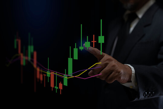 Businessman's hand points candle chart financial growth of business and world economy. Stock market investment analysis, financial risk management and investment. - Powered by Adobe