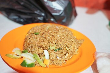 Close-up of traditional nasi goreng with mixed spices and toppings, a popular Indonesian street food.