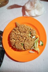 Close-up of traditional nasi goreng with mixed spices and toppings, a popular Indonesian street food.