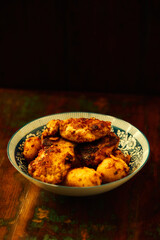 Fried chicken breast with potatoes. Rustic wooden background. Soft focus.	