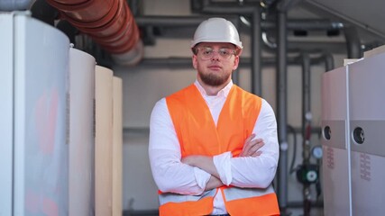Professional engineer, confidently standing, technical facility. Wearing safety vest and hard hat. Focused demeanor. Represents expertise and diligent work in industrial settings.