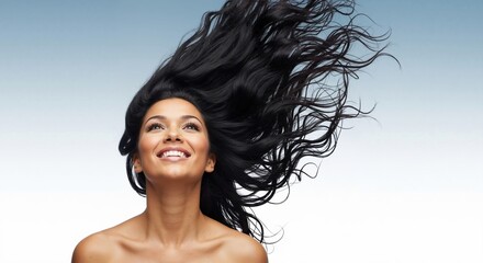 Naklejka premium Happy woman with long healthy black hair blowing in the wind. Beauty model smiling on a gradient background. Hair care and salon concept