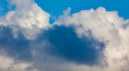 A cloudless blue sky with a few clouds