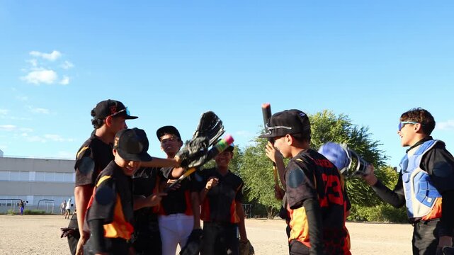 Youth baseball team celebrating with team huddle