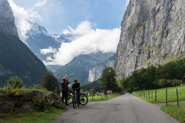 Cyclists enjoying view of jungfrau region mountains and valley