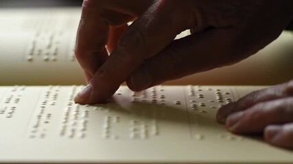 Reading Braille Book with Fingers Closeup for Accessibility