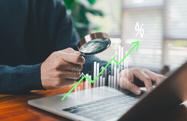 Business professional examining a rising financial chart with a magnifying glass, symbolizing market growth, investment performance, data analytics, economic trends, and business decision-making.