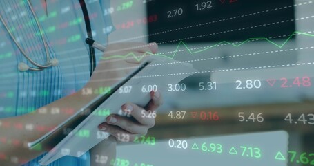 Holding tablet and pen, female nurse in blue scrubs writing at clinic, stethoscope and market data