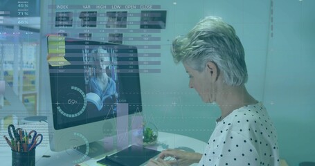 Typing senior woman white polkadot top at desk seeing face with data overlays, keyboard, copy space