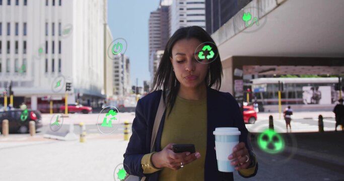 Walking woman in navy blazer holding coffee cup checking phone in downtown plaza with green icons